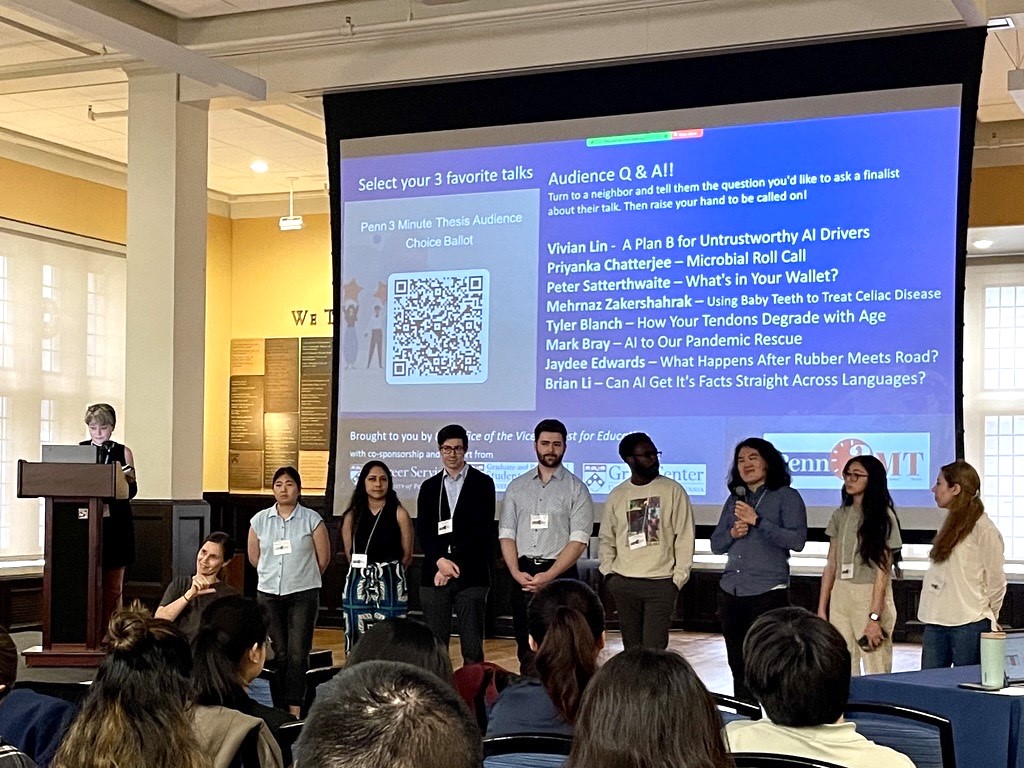 Penn 3MT finalists standing in front of a projector screen facing audience